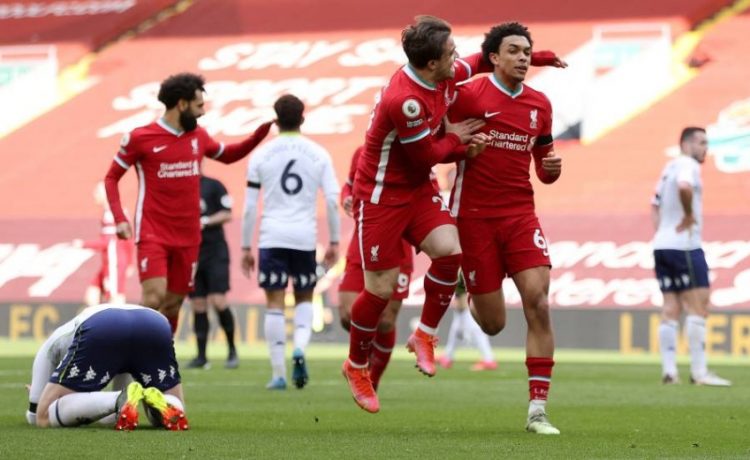 Liverpool's English defender Trent Alexander-Arnold (R) celebrates scoring his team's second goal during the English Premier League football match between Liverpool and Aston Villa at Anfield in Liverpool, north west England on April 10, 2021. (Photo by Clive Brunskill / POOL / AFP) / RESTRICTED TO EDITORIAL USE. No use with unauthorized audio, video, data, fixture lists, club/league logos or 'live' services. Online in-match use limited to 120 images. An additional 40 images may be used in extra time. No video emulation. Social media in-match use limited to 120 images. An additional 40 images may be used in extra time. No use in betting publications, games or single club/league/player publications. /