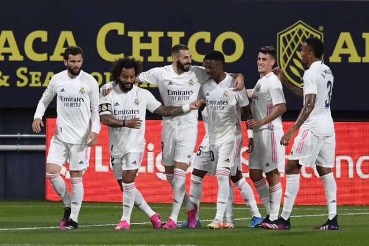 Real Madrid's Karim Benzema, third left, celebrates with teammates after scoring the opening goal during the Spanish La Liga soccer match between Cadiz and Real Madrid at the Ramon Carranza stadium in Cadiz, Spain, Wednesday, April 21, 2021. (AP Photo/Jose Breton)