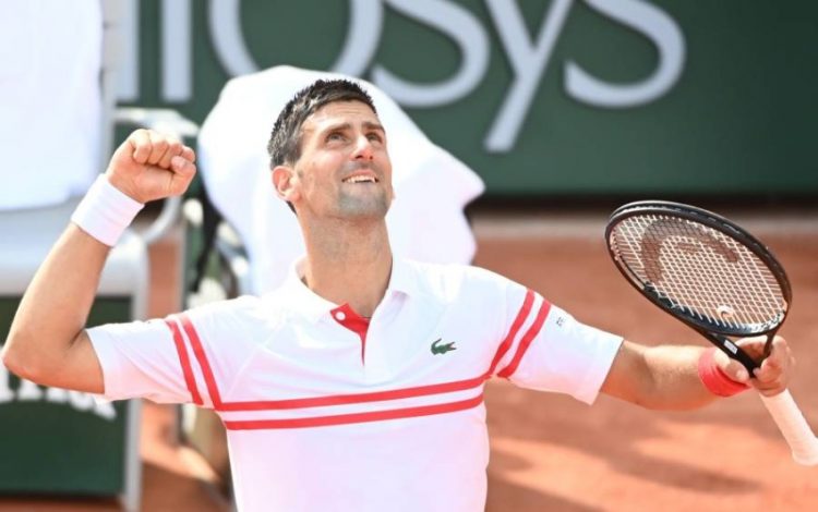 epa09245506 Novak Djokovic of Serbia celebrates winning against Pablo Cuevas of Uruguay during their second round match at the French Open tennis tournament at Roland ​Garros in Paris, France, 03 June 2021.  EPA/CAROLINE BLUMBERG