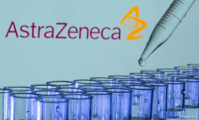 FILE PHOTO: Test tubes are seen in front of a displayed AstraZeneca logo in this illustration taken, May 21, 2021. REUTERS/Dado Ruvic/Illustration/File Photo