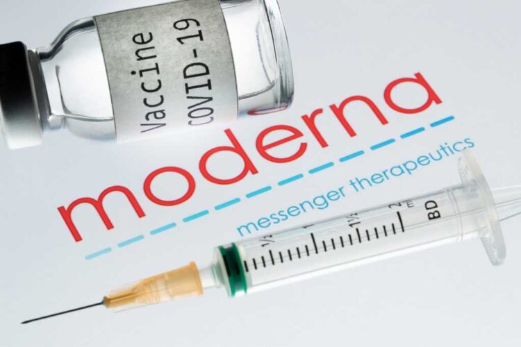 (FILES) In this file photo taken on November 18, 2020 shows a syringe and a bottle reading "Vaccine Covid-19" next to the Moderna biotech company logo. - The United States said December 11, 2020, it was purchasing 100 million more doses of Moderna's Covid-19 vaccine candidate, amid reports the country passed on the opportunity to secure more supply of the Pfizer jab. (Photo by JOEL SAGET / AFP) / -- IMAGE RESTRICTED TO EDITORIAL USE - STRICTLY NO COMMERCIAL USE --