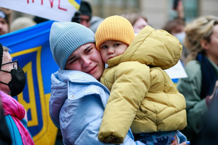 Demonstrators protest in support of Ukraine, in Times Square New York, on February 24, 2022.  Russian President Vladimir Putin launched a full-scale invasion of Ukraine on Thursday, unleashing air strikes and ordering ground troops across the border in fighting that Ukrainian authorities said left dozens of people dead. (Photo by KENA BETANCUR / AFP)