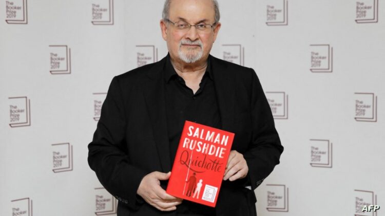 British author Salman Rushdie poses with his book 'Quichotte' during the photo call for the authors shortlisted for the 2019 Booker Prize for Fiction at Southbank Centre in London on October 13, 2019. (Photo by Tolga AKMEN / AFP)