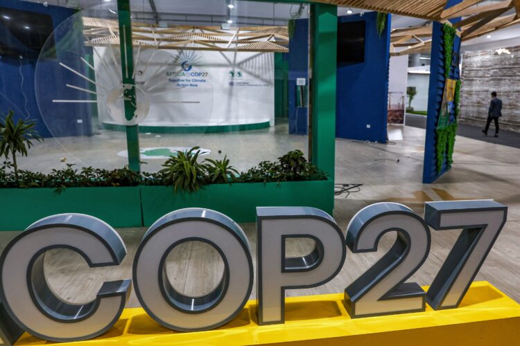 A person walks near the COP27 climate conference at the deserted hall at the Sharm el-Sheikh International Convention Centre, in Egypt's Red Sea resort city of the same name near the end of the climate conference on November 19, 2022. (Photo by AHMAD GHARABLI / AFP) (Photo by AHMAD GHARABLI/AFP via Getty Images)