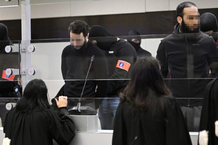 Defendants Salah Abdeslam (L) and Sofien Ayari arrive at the opening of the trial against the nine alleged jihadists accused of taking part in the March 2016 suicide bombings, at the Justitia building in Brussels on November 30, 2022. - Belgium's worst peacetime massacre left 32 dead and hundreds marked for life. Now, six and a half years later, Brussels will host its biggest ever criminal trial. (Photo by Didier LEBRUN / POOL / AFP)