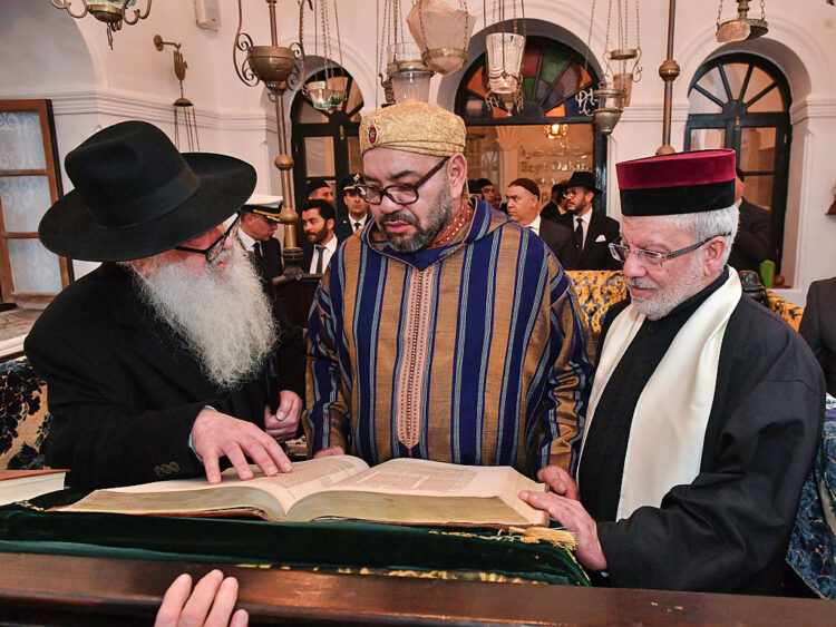 (FILES) This file handout photo provided by the Moroccan Royal Palace on January 15, 2020, shows Morocco's King Mohammed VI (C) during a visit to the "Bayt Dakira" (House of Memory) museum, in the Atlantic coastal city of Essaouira. - Jewish history and culture in Morocco will now be part of the school curriculum -- a "first" in the region and in the North African country, where Islam is the state religion. Morocco's Jewish community has been present since antiquity and grew over the centuries, particularly with the arrival of Jews expelled from Spain by the Catholic kings after 1492. (Photo by - / Moroccan Royal Palace / AFP) / == RESTRICTED TO EDITORIAL USE - MANDATORY CREDIT "AFP PHOTO /HO/ MOROCCAN ROYAL PALACE" - NO MARKETING NO ADVERTISING CAMPAIGNS - DISTRIBUTED AS A SERVICE TO CLIENTS ==