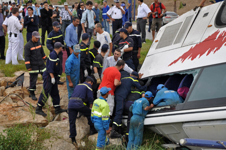 Rescue workers check the debris of an overturned tourist bus in northern Morocco September 8, 2010. Eight Portuguese tourists were killed and 13 wounded on Wednesday when their bus overturned in northern Morocco, local government officials said. The bus was travelling from the Spanish enclave of Ceuta towards the Moroccan city of Tetouan when the accident occurred near the Errifiyyines area, the officials told Reuters. REUTERS/Stringer (PORTUGAL - Tags: DISASTER) THIS IMAGE HAS BEEN SUPPLIED BY A THIRD PARTY. IT IS DISTRIBUTED, EXACTLY AS RECEIVED BY REUTERS, AS A SERVICE TO CLIENTS