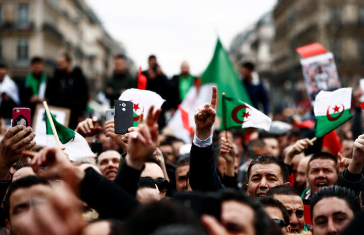 Demonstrators gather near the Monument to the Republic during a protest against Algerian President Abdelaziz Bouteflika seeking a fifth term in a presidential election set for April 18, in Paris, France, March 3, 2019. REUTERS/Christian Hartmann