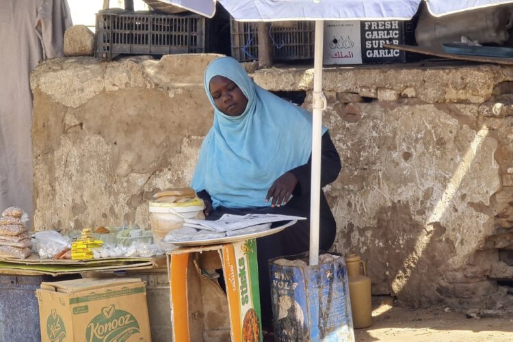 (FILES) A woman sells foodstuffs at a stall on a market street in southern Khartoum on May 21, 2023, amid ongoing fighting between two rival generals. Out of work as fighting rages between the forces of rival generals, many Sudanese have been forced to find creative ways to support themselves and their families. (Photo by AFP)