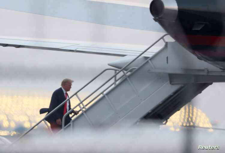 Former U.S. President Donald Trump boards his plane at Atlanta Hartsfield-Jackson International Airport after turning himself in to be processed at Fulton County Jail after his Georgia indictment, in Atlanta, Georgia, U.S., August 24, 2023. REUTERS/Ricardo Arduengo