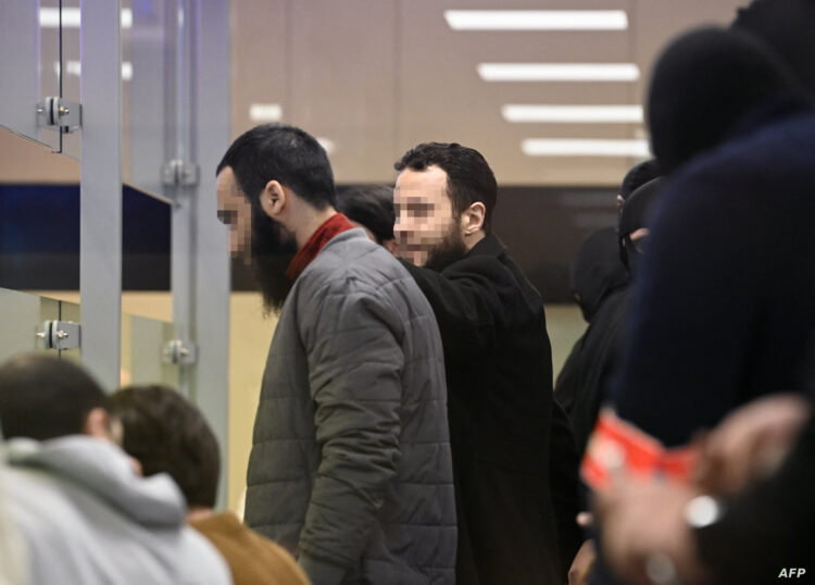 Defendants Salah Abdeslam (C) and Sofien Ayari (L) speak in court during the trial of the 2016 Brussels terror attacks, at the Justitia building in Brussels on April 3, 2023. Nine defendants are on trial over the March 22, 2016, bomb attacks attacks at Brussels' Zaventem airport and Maelbeek metro station, that killed 32 people, and which were claimed by the Islamic State (IS) group. (Photo by John THYS / POOL / AFP)