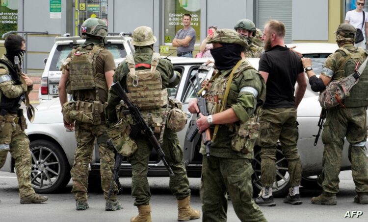 Members of Wagner group inspect a car in a street of Rostov-on-Don, on June 24, 2023. President Vladimir Putin on June 24, 2023 said an armed mutiny by Wagner mercenaries was a "stab in the back" and that the group's chief Yevgeny Prigozhin had betrayed Russia, as he vowed to punish the dissidents. Prigozhin said his fighters control key military sites in the southern city of Rostov-on-Don. (Photo by STRINGER / AFP)