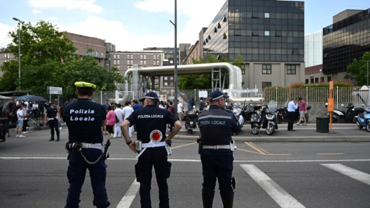 Police and members of the media stand outside the San Raffaele hospital, where Italian businessman and former prime minister Silvio Berlusconi has died, in Milan on June 12, 2023. Italy's former prime minister Silvio Berlusconi has died aged 86, his spokesman confirmed to AFP on June 12, 2023. The billionaire media mogul was admitted to a Milan hospital on June 9 for what aides said were pre-planned tests related to his leukemia. (Photo by GABRIEL BOUYS / AFP)