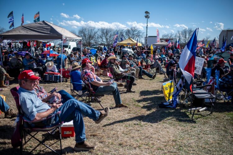 Attendees listen to a speech at the Take Back Our Border Convoy rally at Cornerstone Children's Ranch on February 3, 2024 near Quemado, Texas. - In trucks, vans and RVs, hundreds of people converged Saturday in southern Texas to rally against what they say is a migrant "invasion" and to demand tough new controls at the US border with Mexico. (Photo by SERGIO FLORES / AFP)